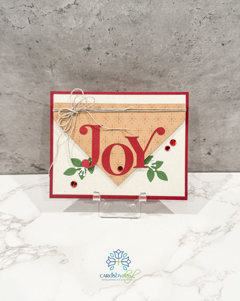 A festive Christmas card that says "Joy"